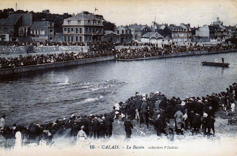 Foule rassemblée de chaque côté du bassin de natation lors d'un concours.